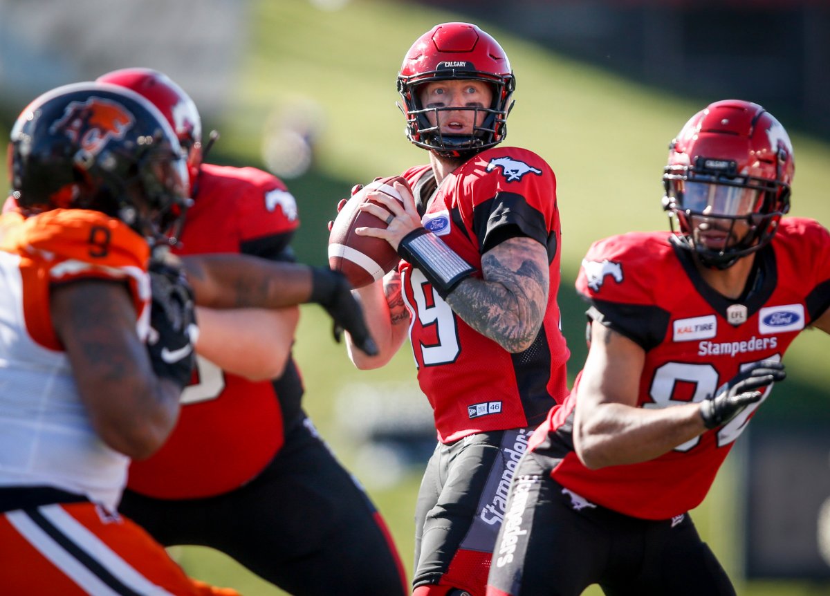 Calgary Stampeders quarterback Bo Levi Mitchell, centre, looks for a receiver during first half CFL football action against the B.C. Lions, in Calgary, Saturday, June 29, 2019. 