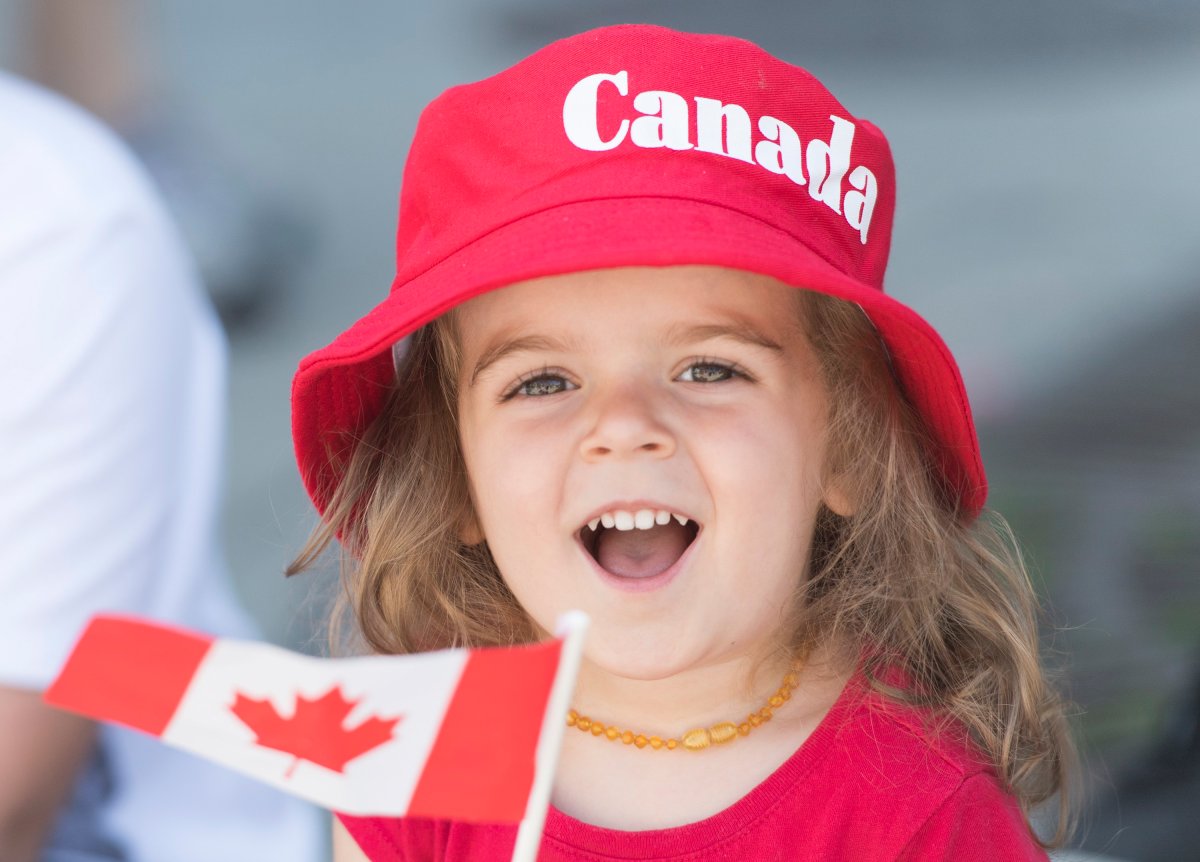 A young girl smiles during the annual Canada Day parade in Montreal, Monday, July 1, 2019.