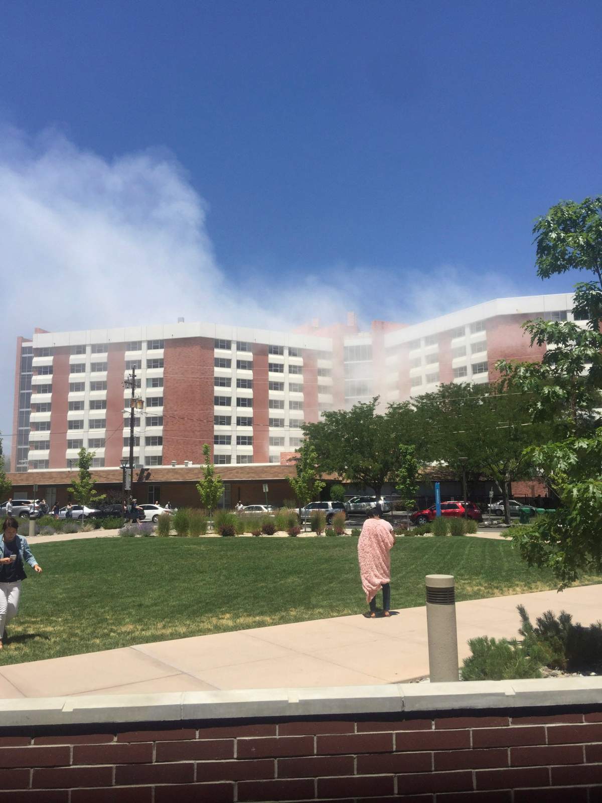 Plumes of smoke from an explosion inside a residence hall at the University of Nevada, Reno in Reno, Nev., is visible on Friday, July 5, 2019. Police referred to the incident as a “utilities accident.” There were no immediate reports of injuries. (Raymond Floyd via The AP)