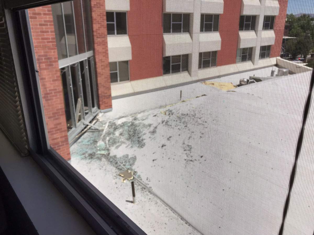 In this photo provided by Raven Green, is damage to a dormitory building with windows blown out and other debris that fell after an explosion at the University of Nevada, Reno, Friday, July 5, 2019, in Reno, Nev. (Raven Green via AP)