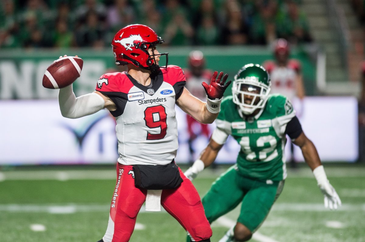 Calgary Stampeders quarterback Nick Arbuckle (9) looks for a receiver under pressure from Saskatchewan Roughriders linebacker Micah Teitz (43) during second half CFL action in Regina on Saturday, July 6, 2019. The Calgary Stampeders defeated the Saskatchewan Roughriders 37-10. 