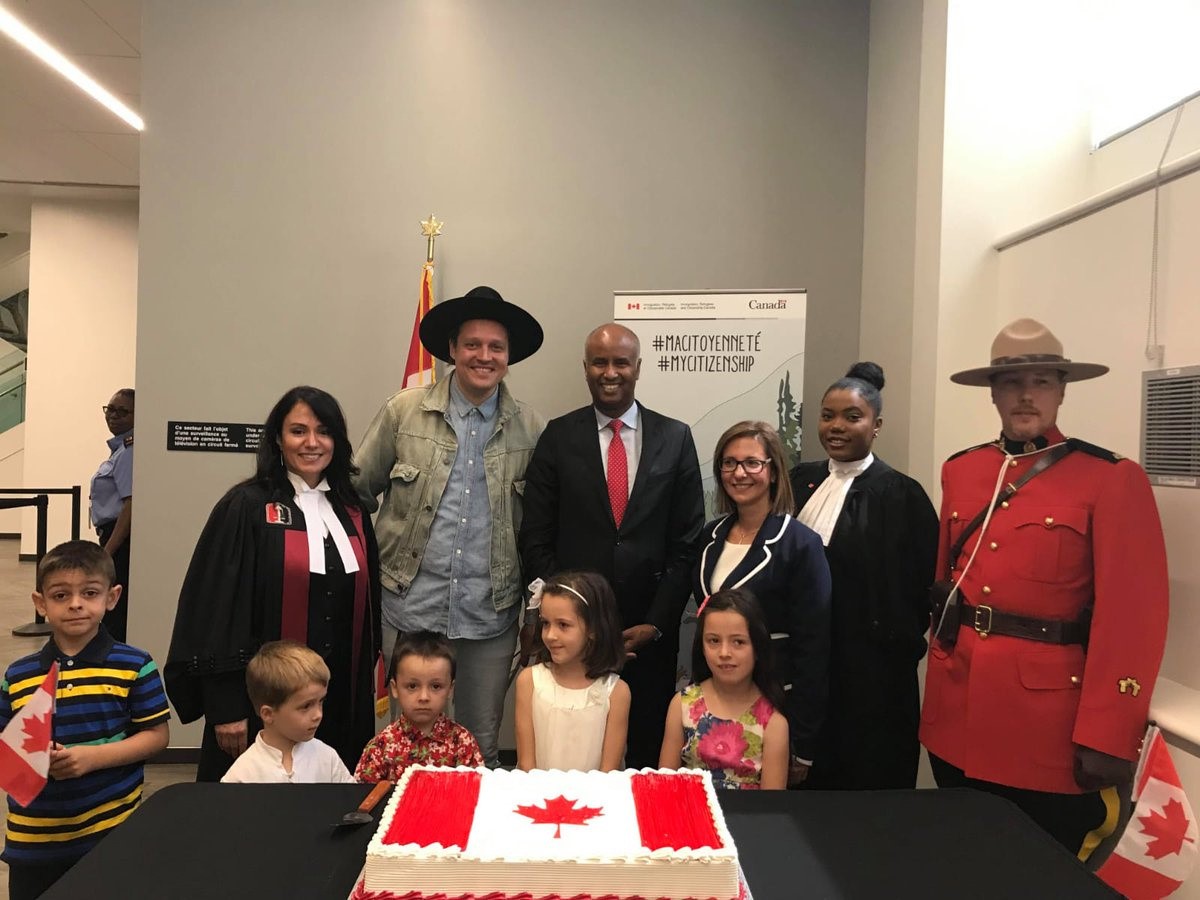 Immigration, Refugees and Citizenship minister Ahmed Hussen, centre, poses with new Canadians, including Arcade Fire frontman Win Butler, after a citizenship ceremony in Montreal in a Tuesday, July 9, 2019, handout photo posted to social media. 