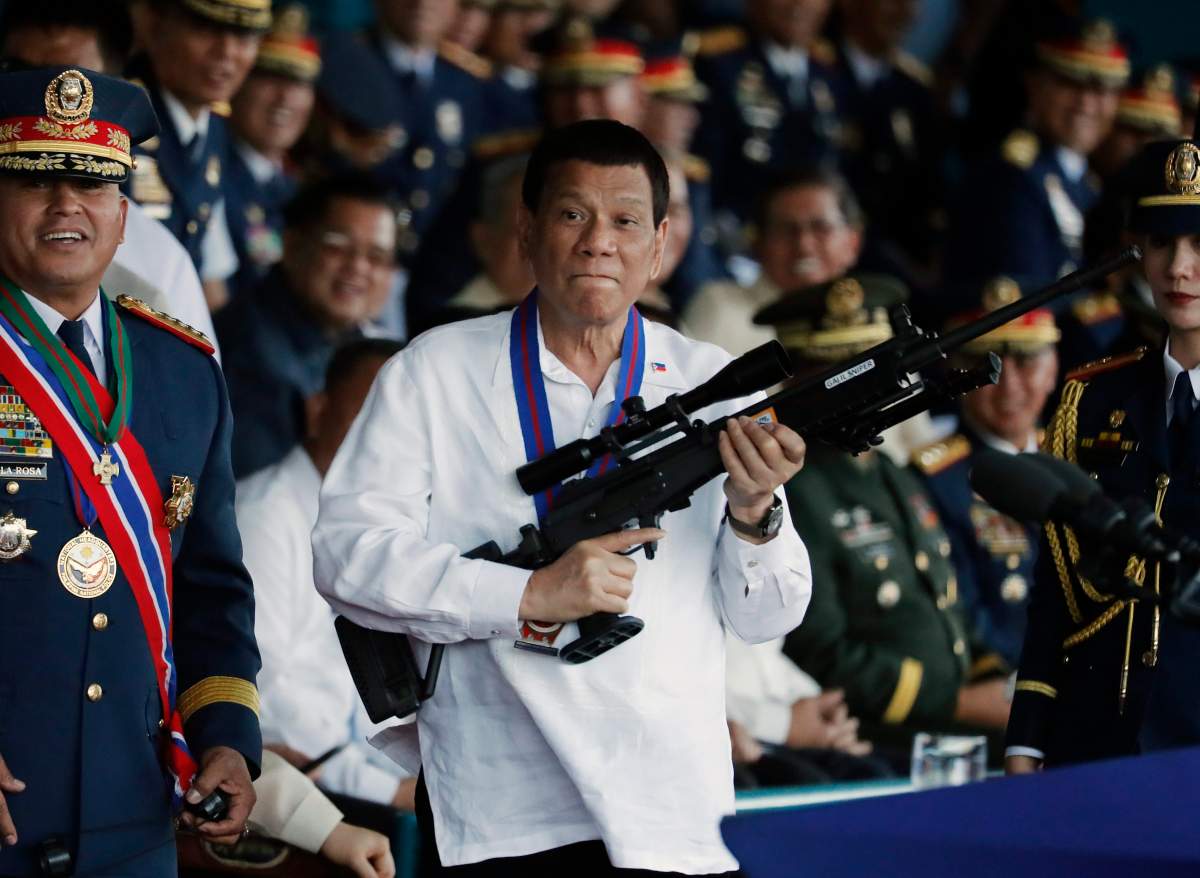 FILE - Filipino President Rodrigo Duterte (C) holds a Galil sniper rifle during the national police chief change of command ceremony inside Camp Crame in Quezon city, east of Manila, Philippines, 19 April 2018 (issued 12 July 2019).