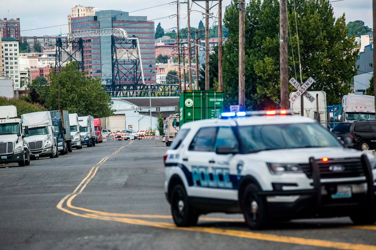 A police officer guards the front of a road block near the Northwest Detention Center, Saturday, July 13, 2019 in Tacoma, Wash. 