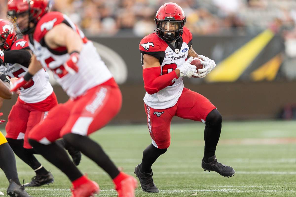 Calgary's Reggie Begelton runs the ball for a  touchdown during second quarter CFL action between the Stampeders and the Hamilton Tiger-Cats in Hamilton, Ontario on Saturday July 13, 2019.