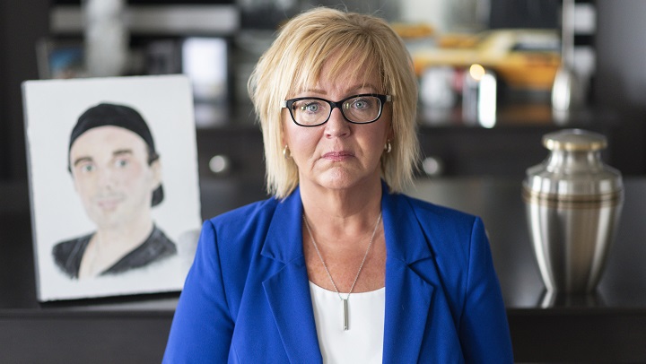 Jenny Churchill poses by a portrait of her son Jordan, who died of a fentanyl overdose in 2018, at her home in Regina on Friday, July 12, 2019.