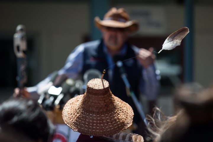 An eagle feather attached to a hat worn by Kwikwetlem First Nation Chief Ed Hall blows in the wind as Chief Joe Alphonse, back, Tribal Chair of the Tsilhqot'in National Government, speaks during a ceremony to commemorate the wrongful trial and hanging of Chief Ahan, in New Westminster, B.C., on Thursday July 18, 2019. Chief Ahan, who was hanged in the city on July 18, 1865, was one of six Tsilhqot'in First Nation chiefs who were executed following the Chilcotin War between the Tsilhqot'in people and European settlers. 