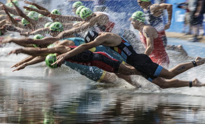 Athletes jump into the water during the Elite Men’s race at the ITU World Triathlon Series in Edmonton on Saturday, July 20, 2019.