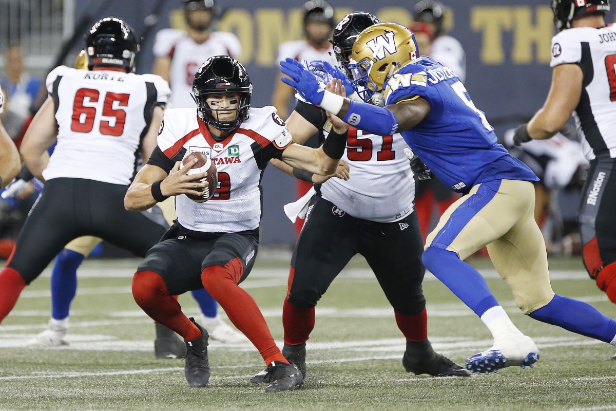 Ottawa Redblacks quarterback William Arndt (8) tries to avoid running into Winnipeg Blue Bombers' Willie Jefferson (5) during the second half of CFL action in Winnipeg, Friday, July 19, 2019. The Ottawa Redblacks are anxious to get back onto the field following a tough week last week in Winnipeg.