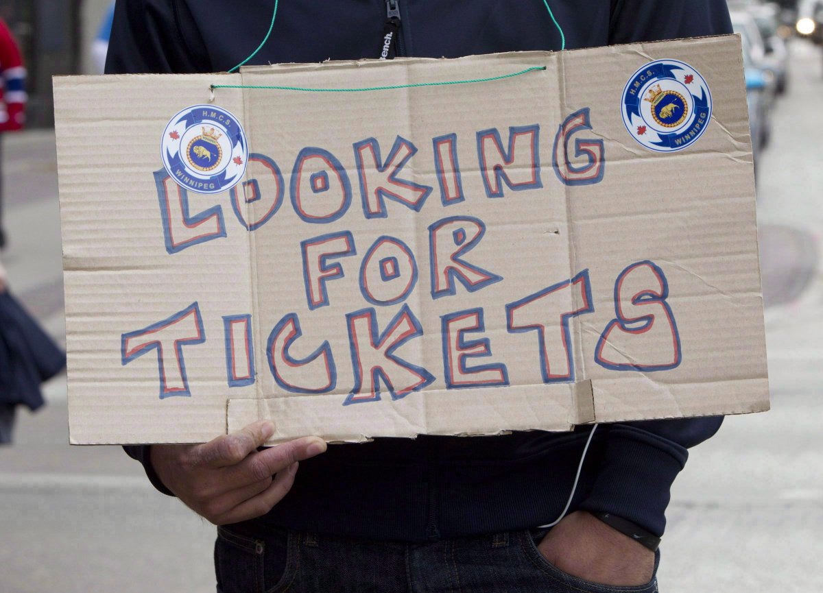 A Winnipeg Jets fan looks for tickets for the Jets inaugural game against the Montreal Canadiens at the MTS Centre in Winnipeg, Sunday, Oct. 9, 2011. 