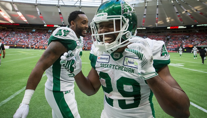 Saskatchewan Roughriders' William Powell, right, and Marcus Thigpen celebrate Powell's third touchdown during the second half of a CFL football game against the B.C. Lions, in Vancouver, on July 27, 2019. 