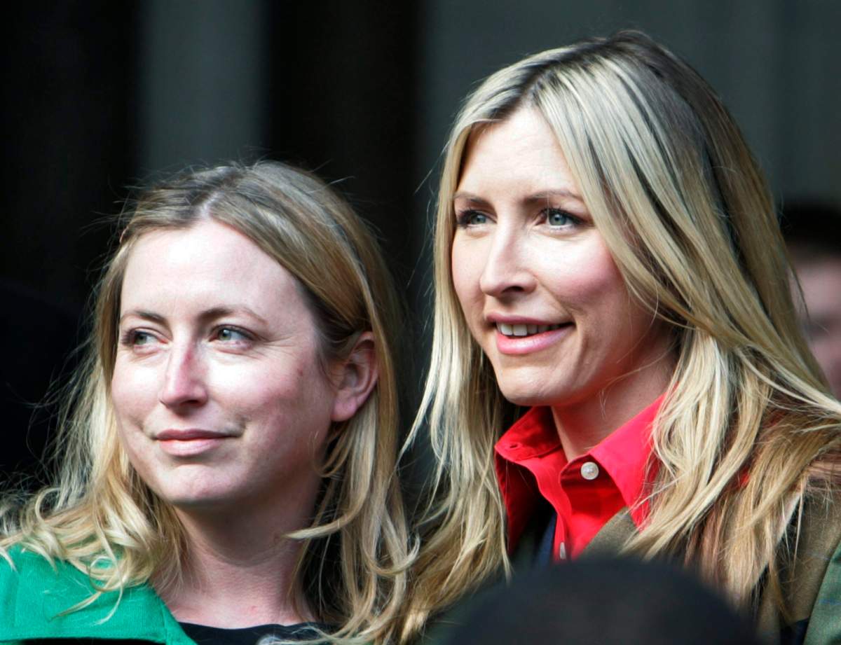 Heather Mills, right, poses for photographers as she leaves central London’s Royal Courts of Justice with her sister Fiona following the announcement of the judgment of her divorce with Paul McCartney on Monday, March 17, 2008.