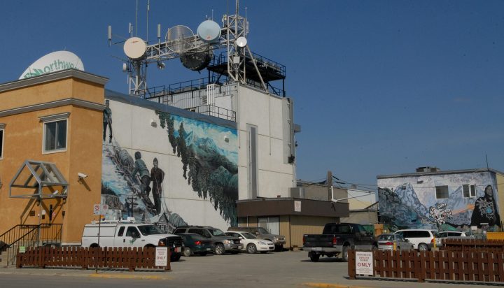 A Northwestel building in downtown Whitehorse, Yukon Territory with murals on the side.