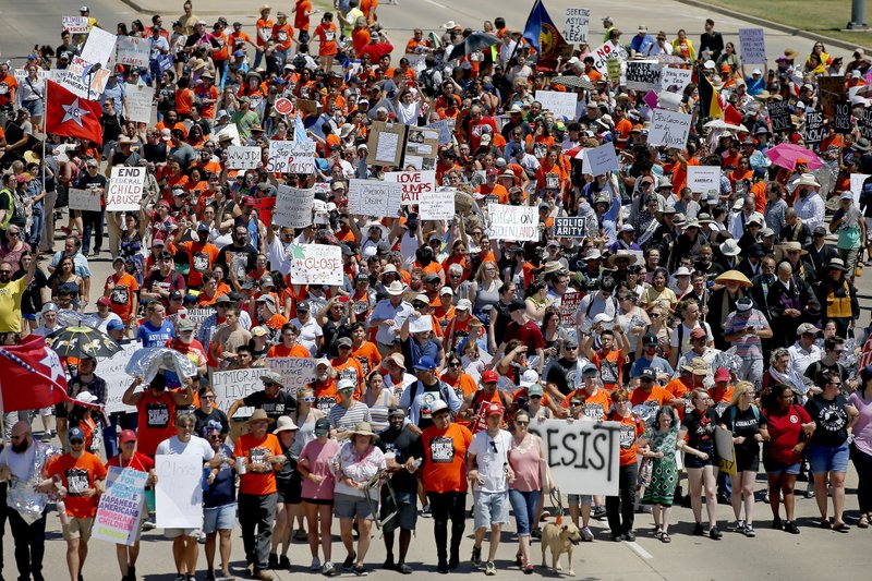 In this July 20, 2019 file photo, protesters march outside Fort Sill in protest of plans to place migrant children at the Army post in Lawton, Okla. 