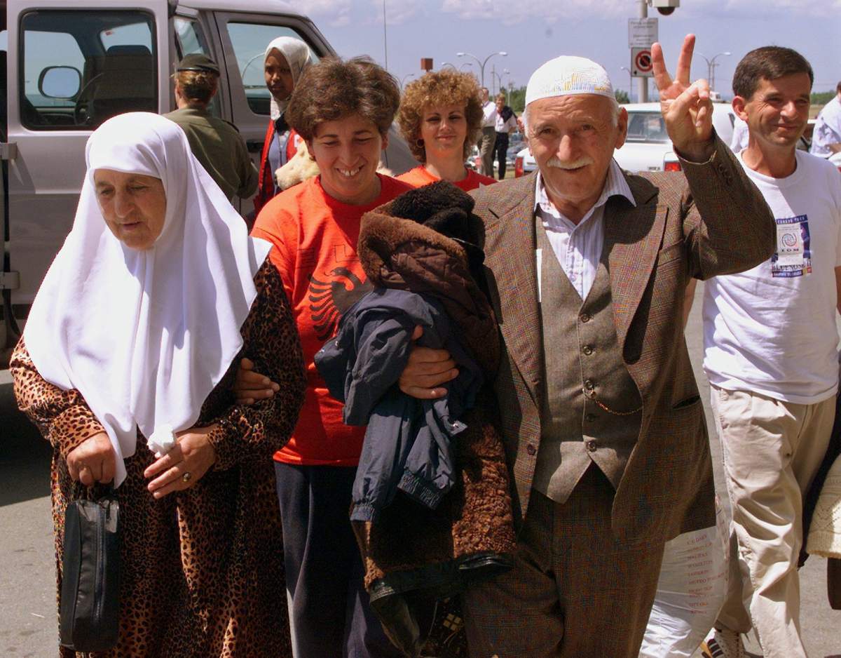 Kosovar refugees arrive at the airport in Halifax on Wednesday, July 7, 1999 as they prepares to board an aircraft to return home.
