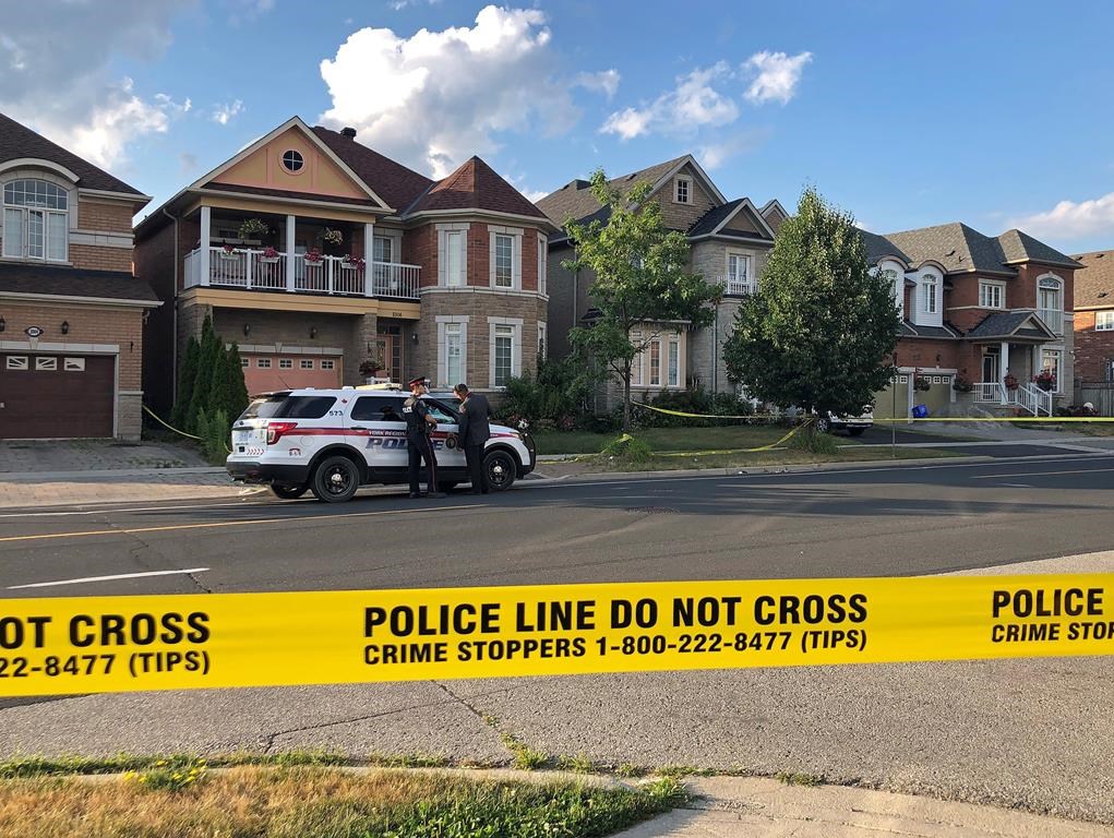 York Regional police officers stand outside of a home in Markham on Sunday, July 28, 2019.