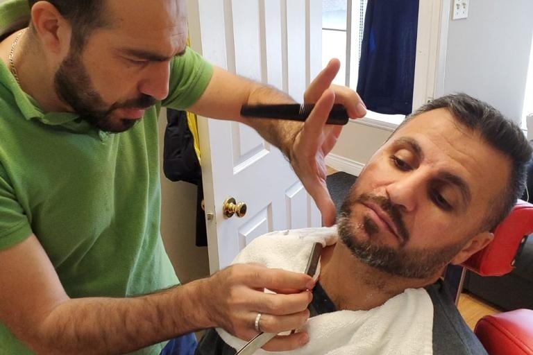 Masoud Al Isso with a customer (Barran Barber Shop)