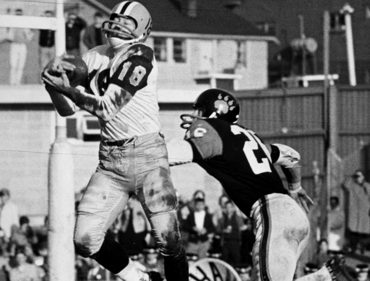 Tommy Grant (18) of the Hamilton Tiger-Cats enfolds a Bernie Faloney pass after beating out British Columbia Lions’ Steve Shafer early in the second period of the Grey Cup game in Vancouver, Nov. 30, 1963.