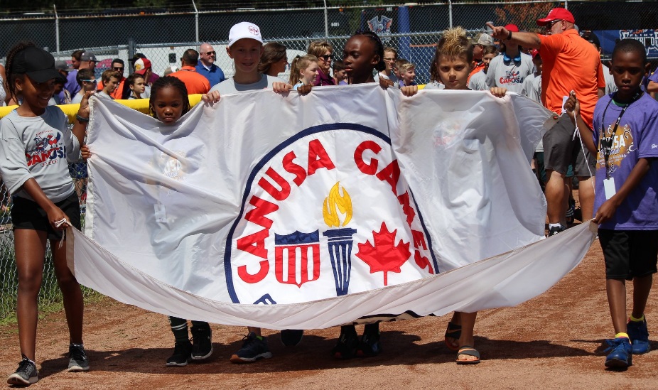 Athletes carry the CANUSA Games flag into the opening ceremonies.