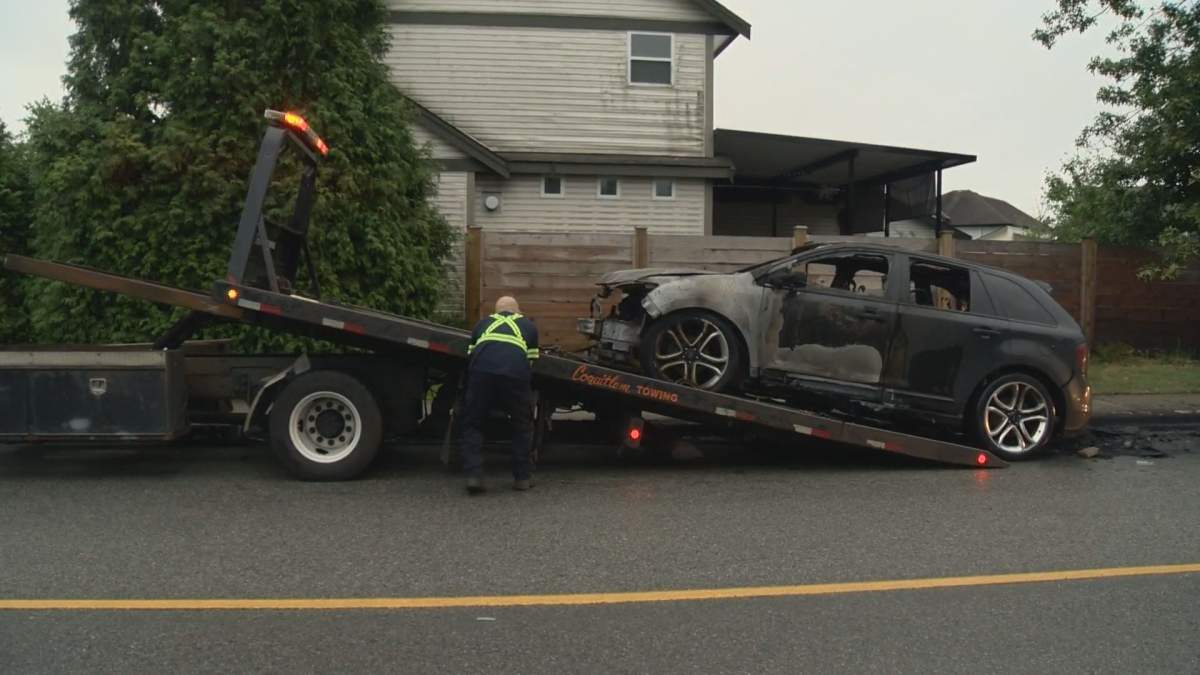 A torched vehicle is towed away from the scene of an overnight car fire in Port Coquitlam.