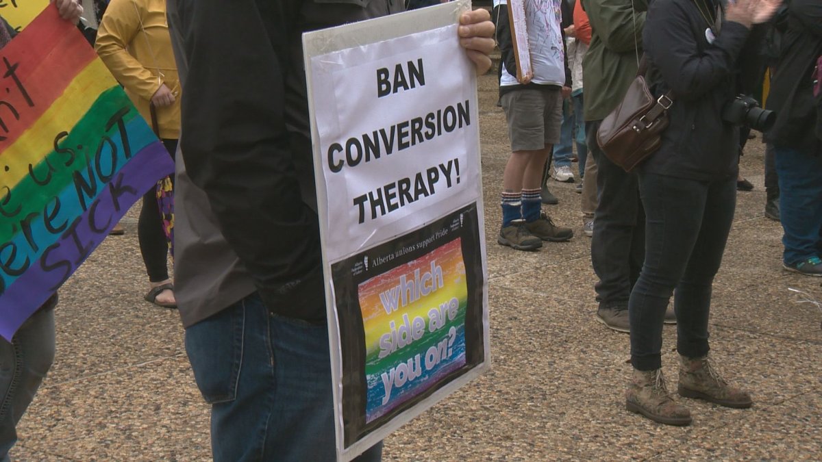 A rally at the Alberta legislature in Summer 2019 with participants calling for the end of conversion therapy.