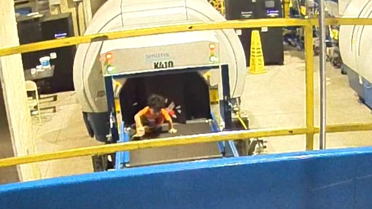 Lorenzo, 2, is shown on a luggage conveyor belt at the Atlanta airport on July 22, 2019.