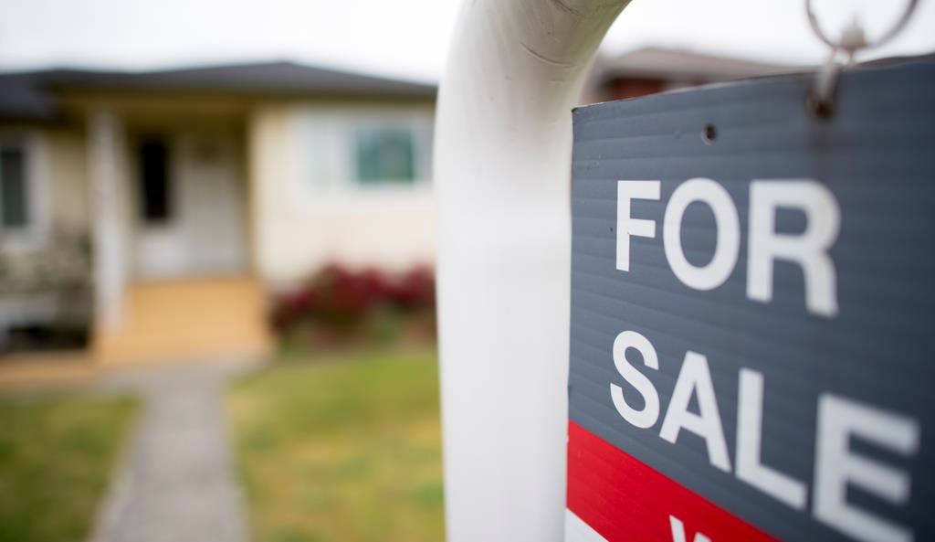 A real estate sign is pictured in Vancouver, B.C., Tuesday, June, 12, 2018.