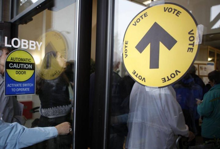 Voters wait in line to cast their ballots both inside and outside the SHOAL Centre on election day in Sidney, B.C., on Oct. 19, 2015. THE CANADIAN PRESS/Chad Hipolito.