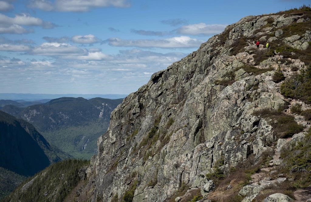 People hike to a lookout point in the Hautes Gorges de la Riviere Malbaie National Park, a park in the Charlevoix region of Quebec, on Sunday, June 10, 2018. Justin Tang/The Canadian Press