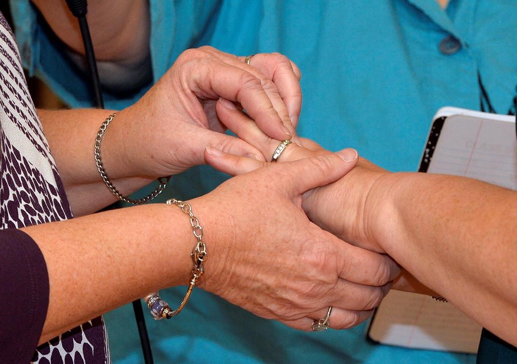 Two women place wedding bands on the finger of their partner as they renew their vows in a public ceremony on Oct. 24, 2015, in Morehead, Ky.
