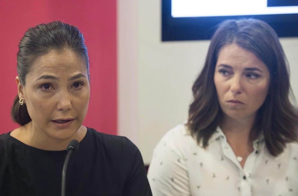 Anna Prchal, left, and Genevieve Simard attend a news conference in Montreal, Monday, June 4, 2018. Three sexual abuse victims of former national ski coach Bertrand Charest have reached an out-of-court settlement with Alpine Canada.
