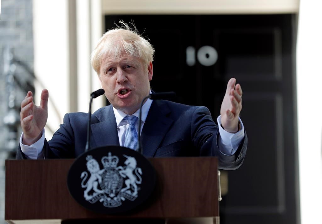 Britain's new Prime Minister Boris Johnson gestures as he speaks outside 10 Downing Street, London, Wednesday, July 24, 2019. Boris Johnson pledged a Halloween Brexit for Britain from the European Union, negotiated or not, "no ifs or buts", after being sworn in Wednesday as Britain's prime minister.
