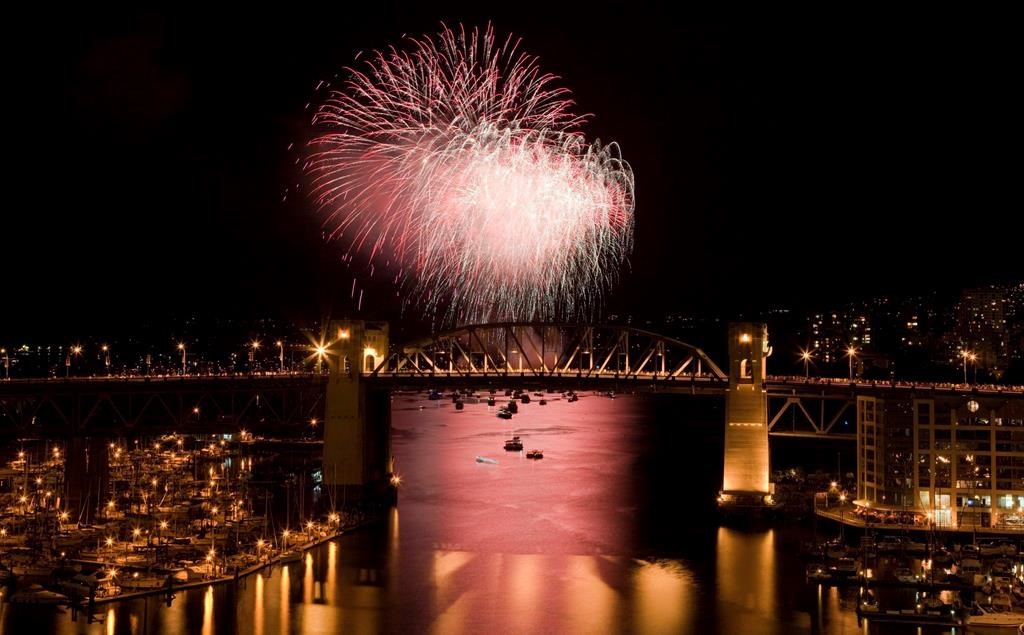 The Burrard Street Bridge is seen in the foreground as fireworks from team China blast over the waters of English Bay during the 21st annual Celebration of Light in Vancouver, Saturday, July 30, 2011. Vancouver's 29th annual fireworks extravaganza is set to showcase the pyrotechnical skills of India, Croatia and Canada as the three countries light up the sky this summer.