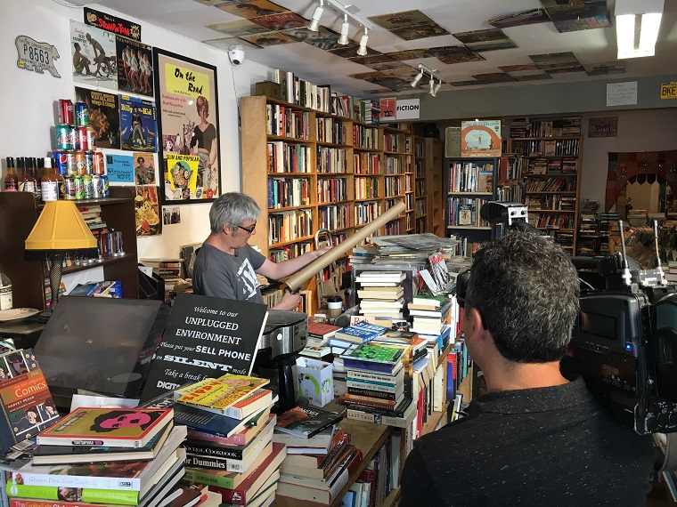 Troubador Books and Records owner Tom Lee prepares to wrap a book.