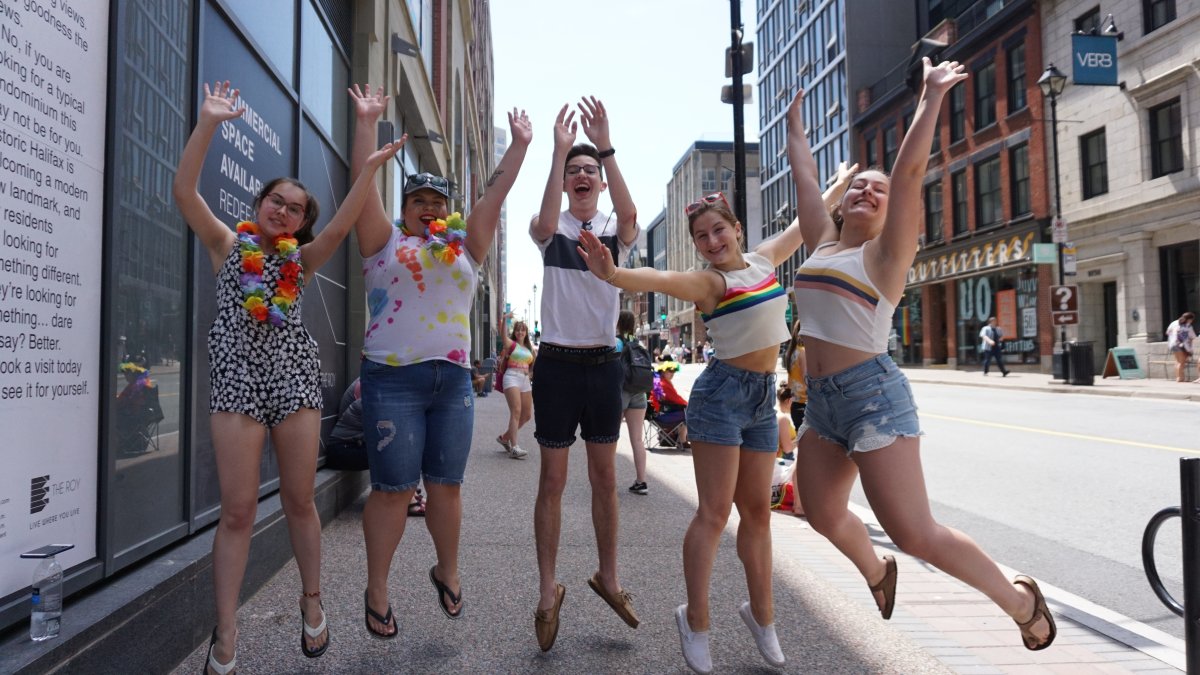 A group jumps for joy as they celebrate the Halifax Pride Parade on July 20, 2019. 