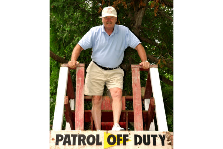 Water safety advocate John Watt poses in front of  the last remaining lifeguard tower at Wasaga Beach.