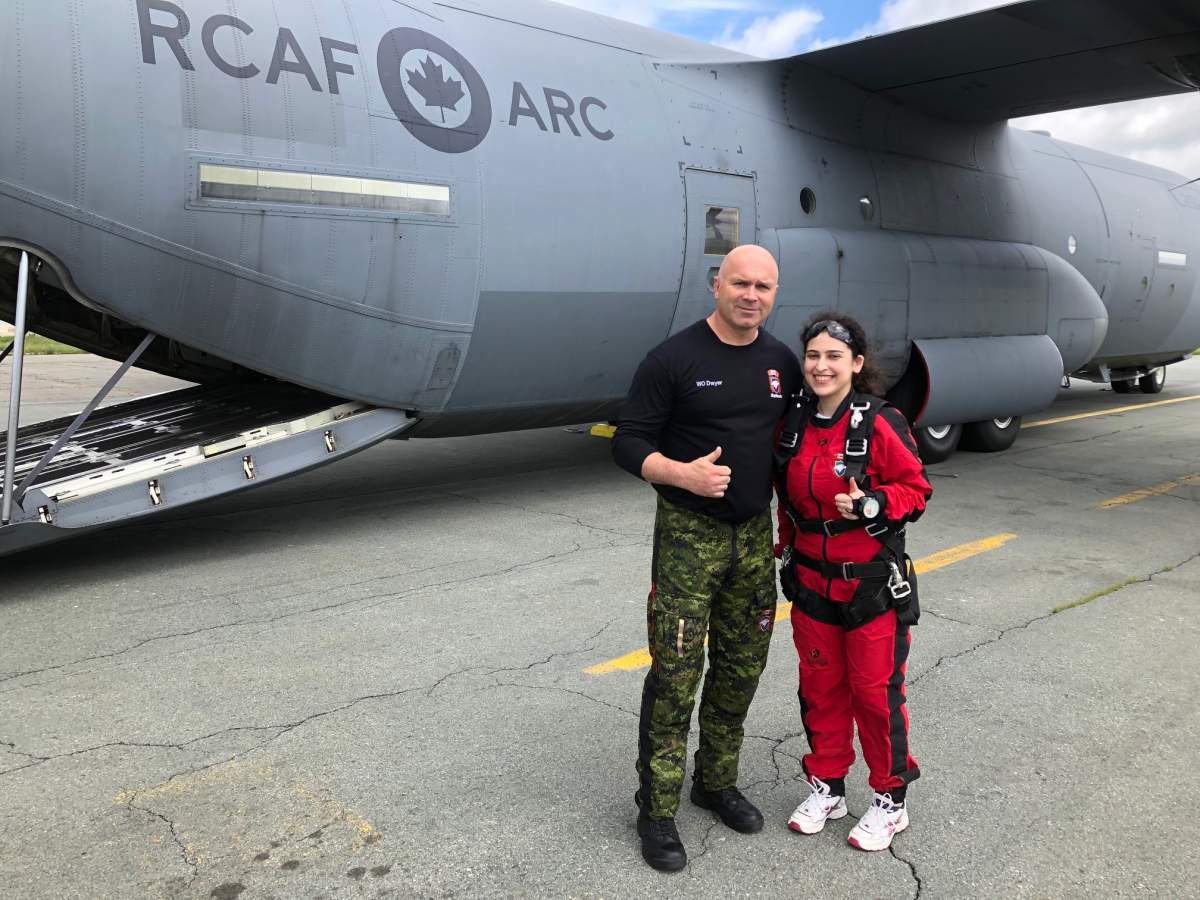 Global News reporter Aya Al-Hakim with Mike Dwyer, her tandem skydiving instructor.