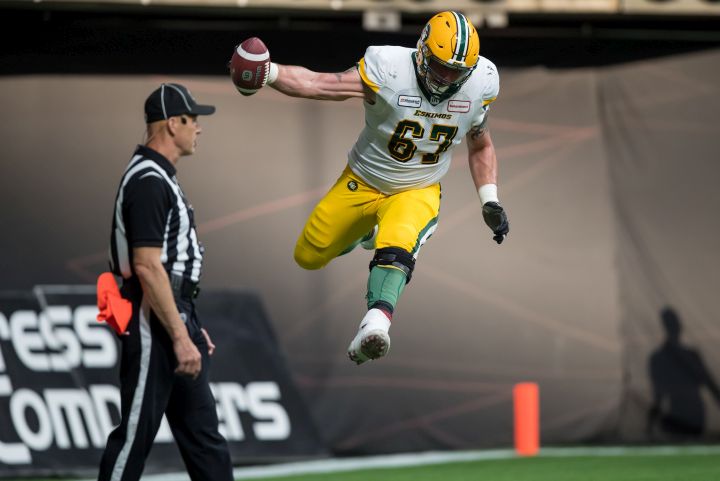 Edmonton Eskimos' Colin Kelly celebrates teammate Trevor Harris' touchdown during first half CFL football action against the B.C. Lions, in Vancouver, on Thursday, July 11, 2019. 