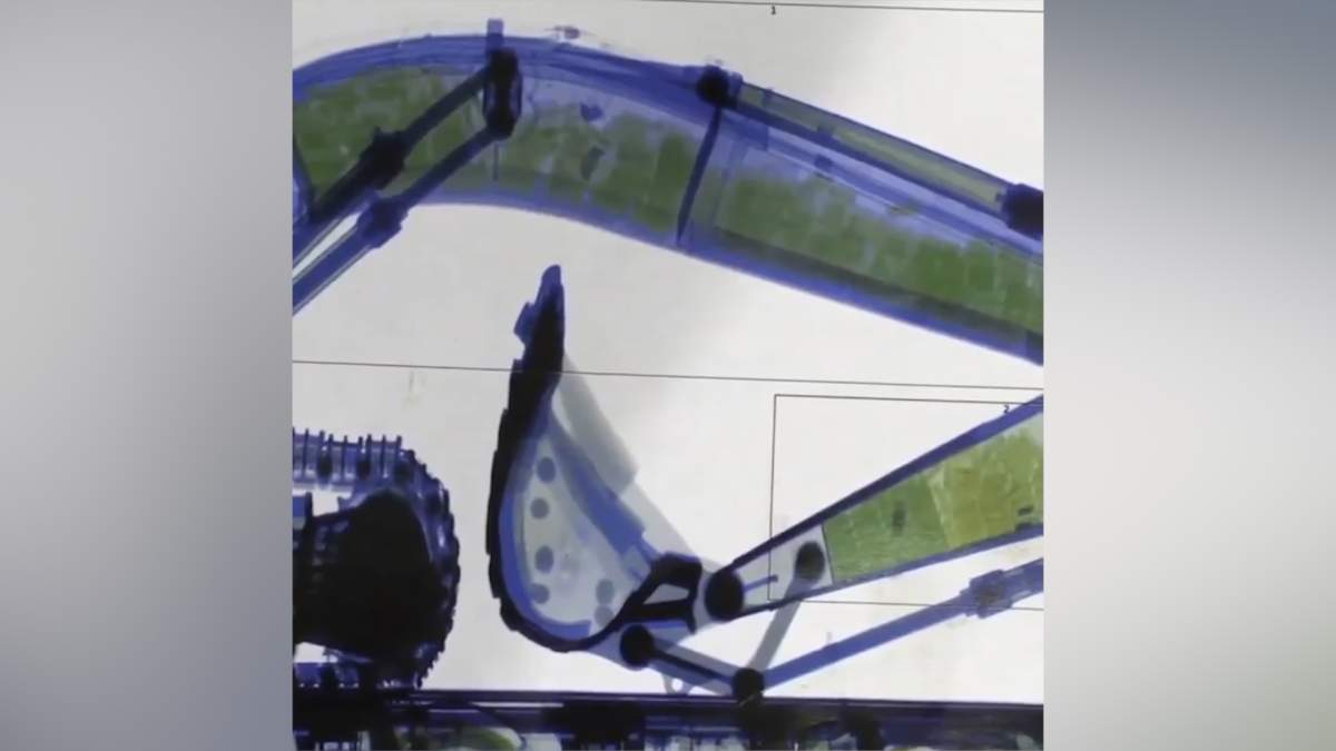 This X-ray photo shows packages of drugs, in yellow, concealed inside the hydraulic arm of an excavator in Sydney, Australia.