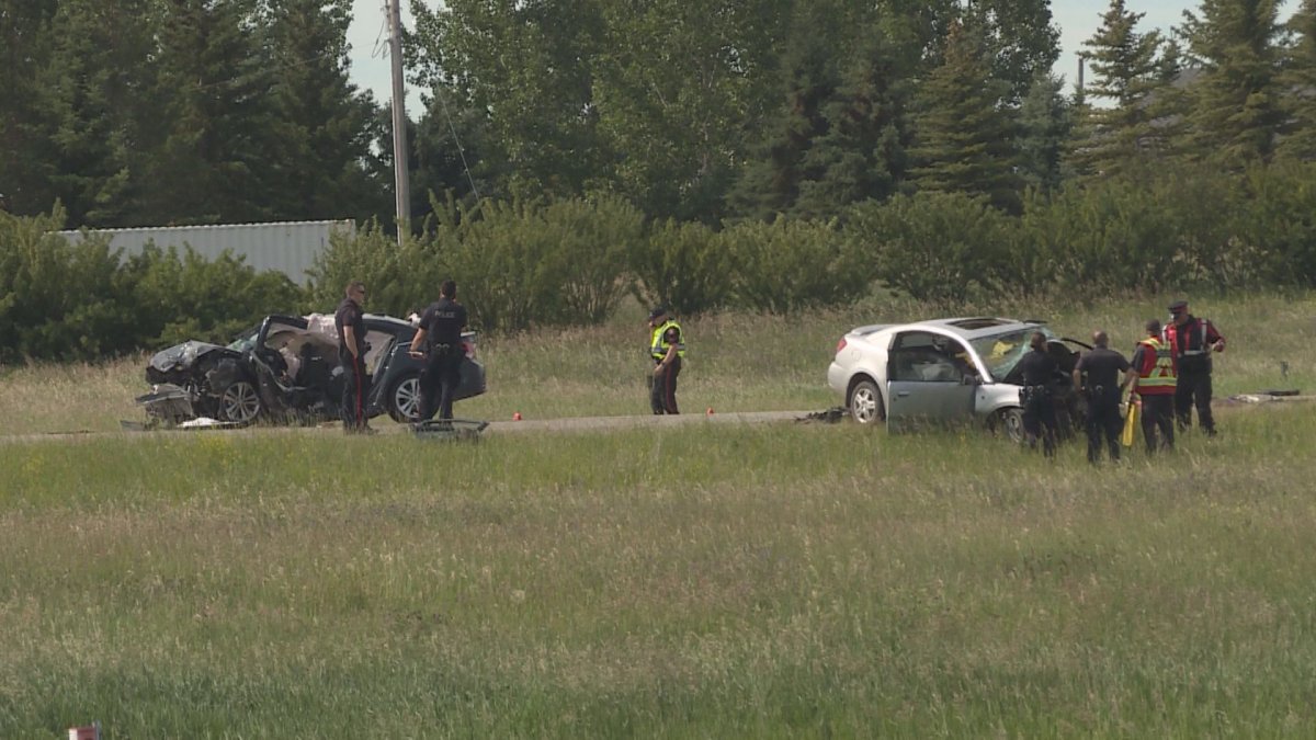 A woman is dead and four men were injured in a two-vehicle crash in Calgary on Saturday. 