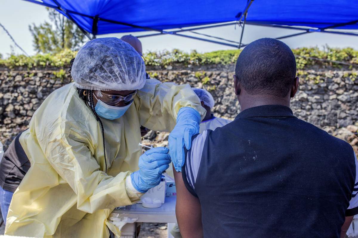 A man receives a vaccine against Ebola from a nurse outside the Afia Himbi Health Centre on July 15, 2019 in Goma.