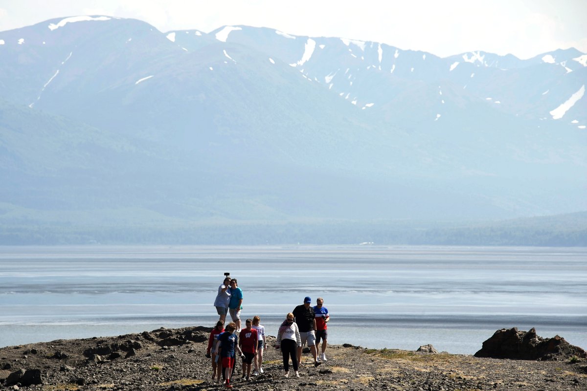 People visit a rock outpost at Beluga Point along the Turnagain Arm on July 4, 2019 south of Anchorage, Alaska.