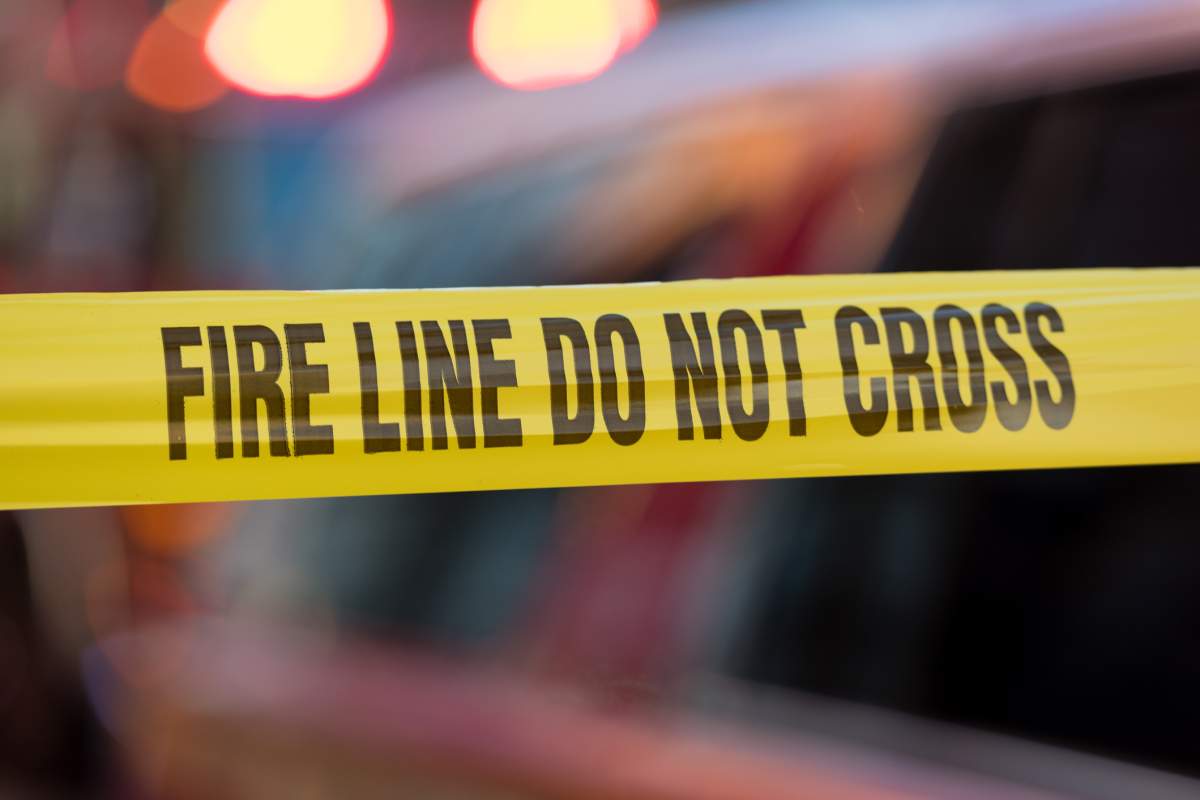 A piece of tape blocking off the scene of a fire. 