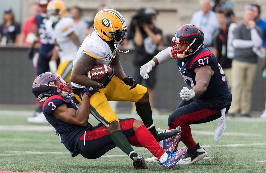 Montreal Alouettes' Patrick Levels (3) brings down Edmonton Eskimos' C.J. Gable as Alouettes' Woody Baron moves in during second half CFL football action in Montreal, Saturday, July 20, 2019.