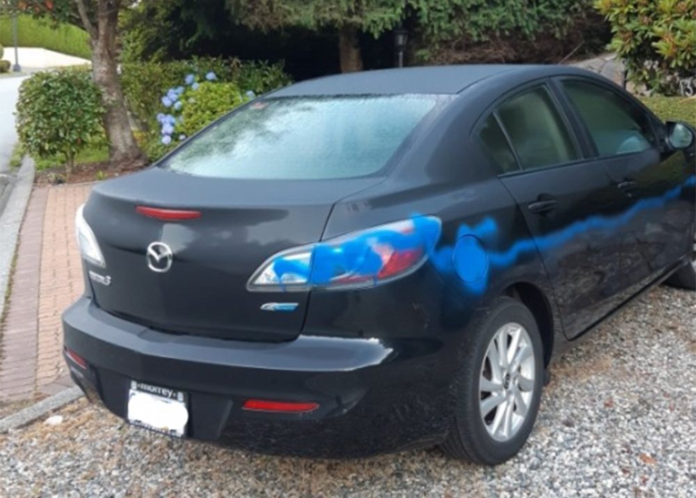 Blue graffiti on a vehicle in a West Vancouver neighbourhood on July 9, 2019. Several other vehicles, mailboxes and property were tagged with graffiti, some of them containing racist slogans, police say.