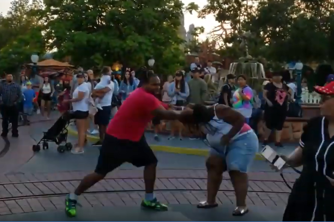 A man pulls a woman’s hair in a fight at Disneyland in Anaheim, Calif., on July 6, 2019.
