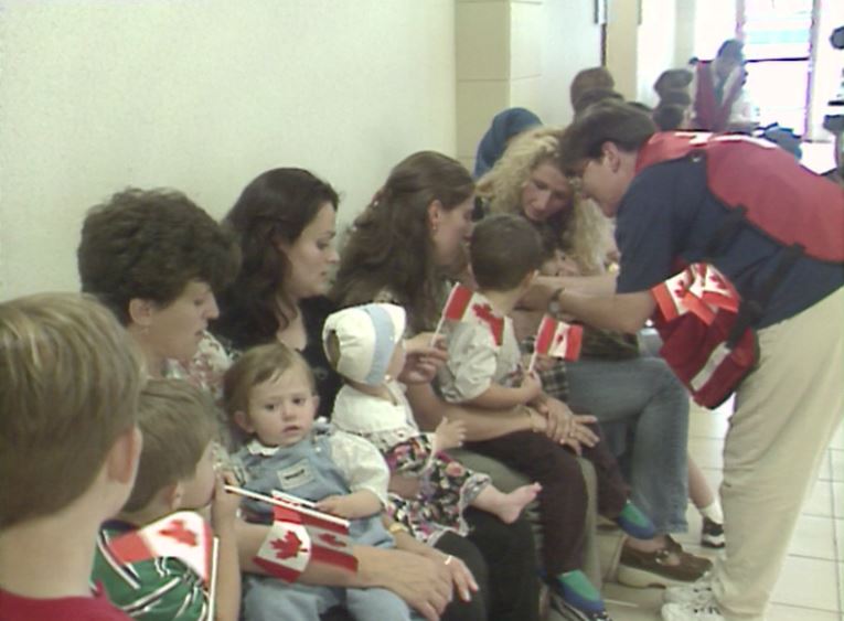 Kosovar refugees rest after arriving in Halifax in May of 1999.