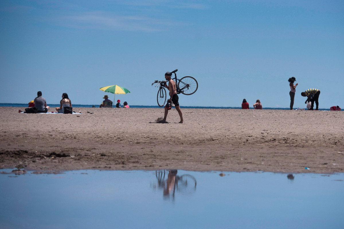 People enjoy the sun at Woodbine Beach in Toronto on Tuesday, June 19, 2018. 
