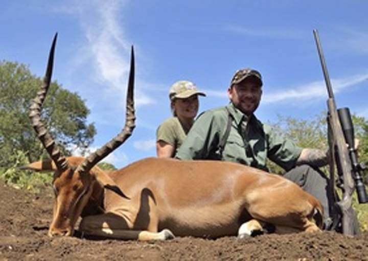 Carolyn and Darren Carter are shown with an animal carcass in this photo posted on their company’s website.
