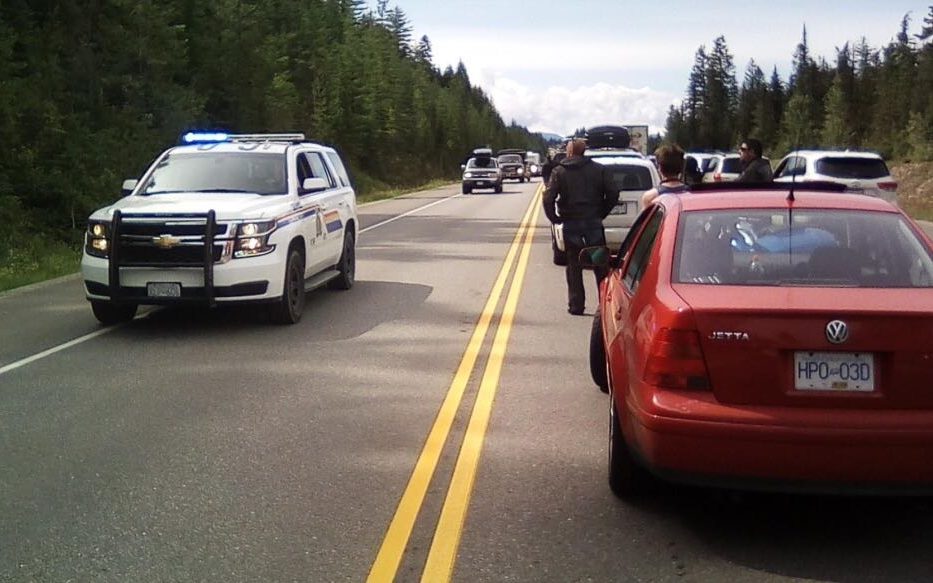 Police on scene near traffic backed up on Highway 1 outside Golden, B.C. due to a serious crash on Saturday, July 20, 2019.